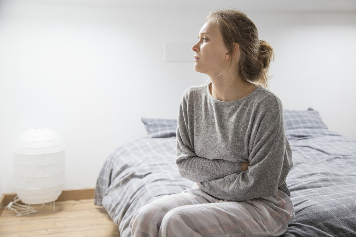woman-with-hands-stomach-suffering-from-pain-looking-aside